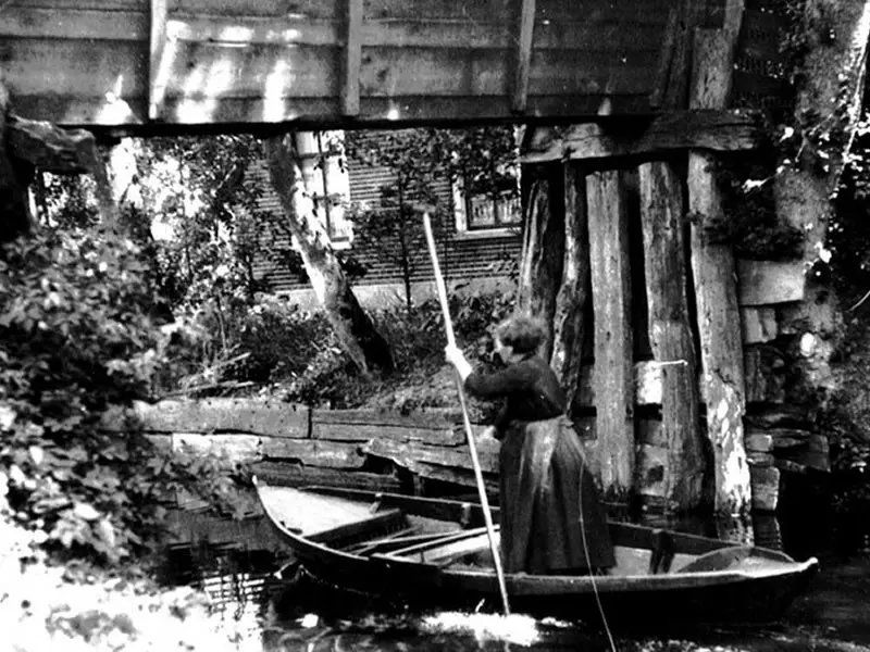 Vrouw puntert in het bootje naar huis.